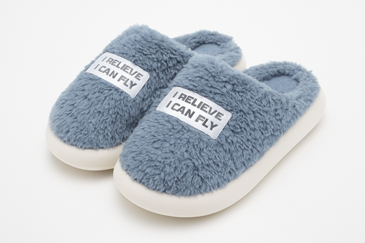 Professional product photo of gray fuzzy slippers with motivational text